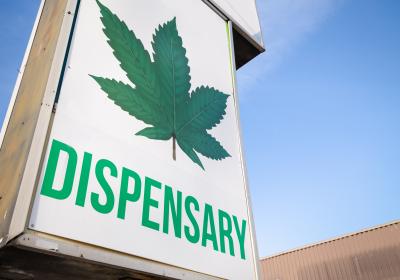 dispensary-sign.jpeg Large dispensary sign against blue sky