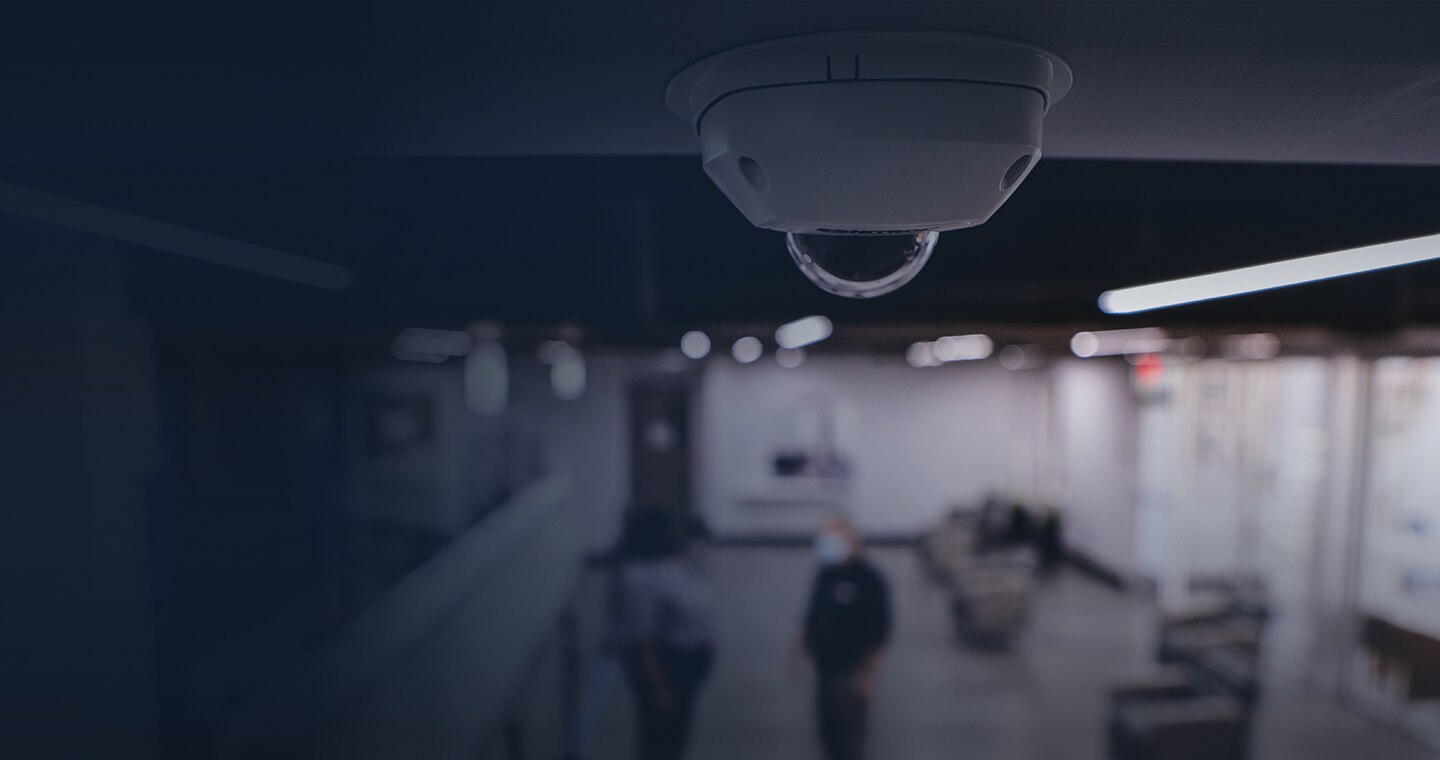 Surveillance camera on ceiling of office.