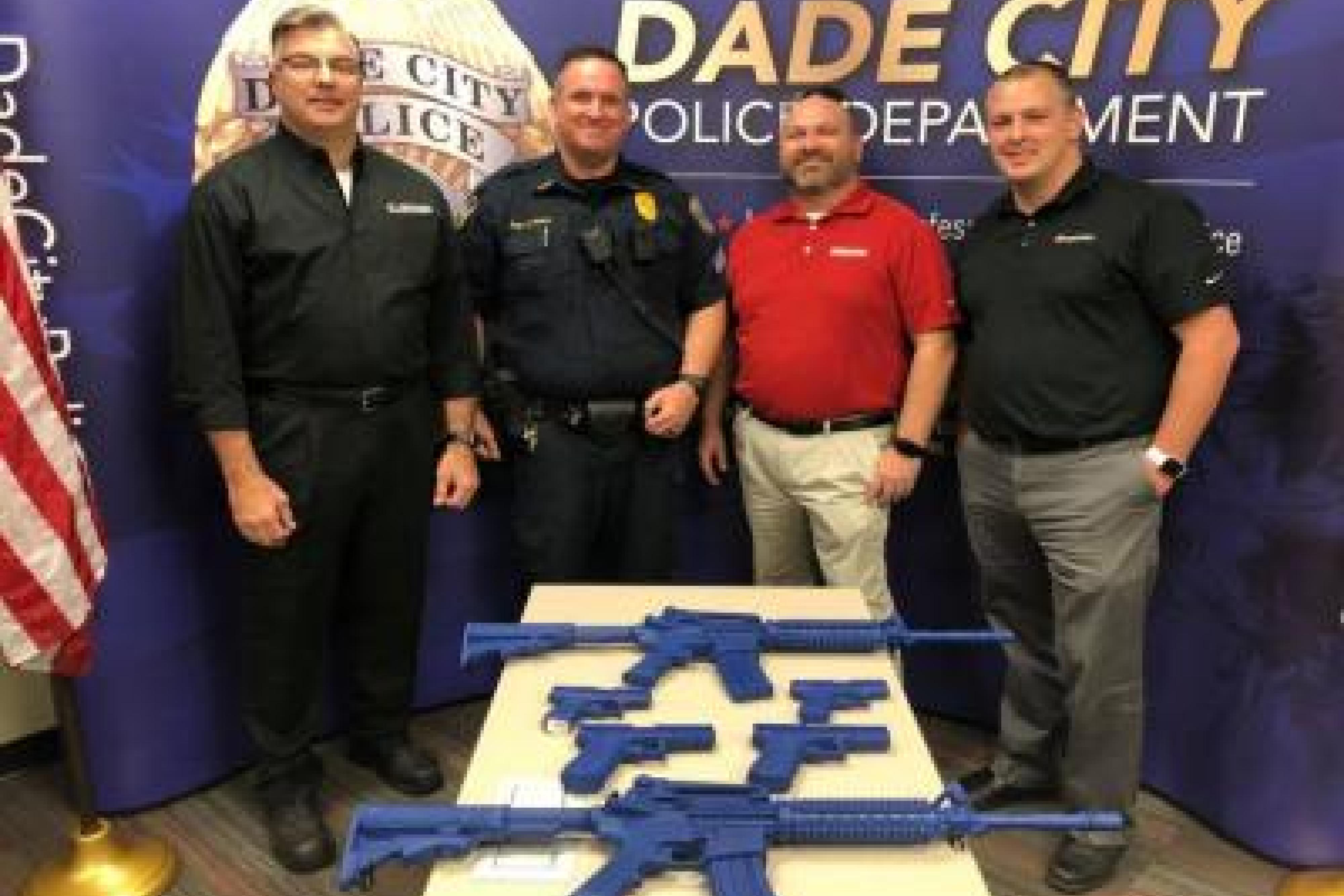 Dade City officers with Sonitrol training weapon donation