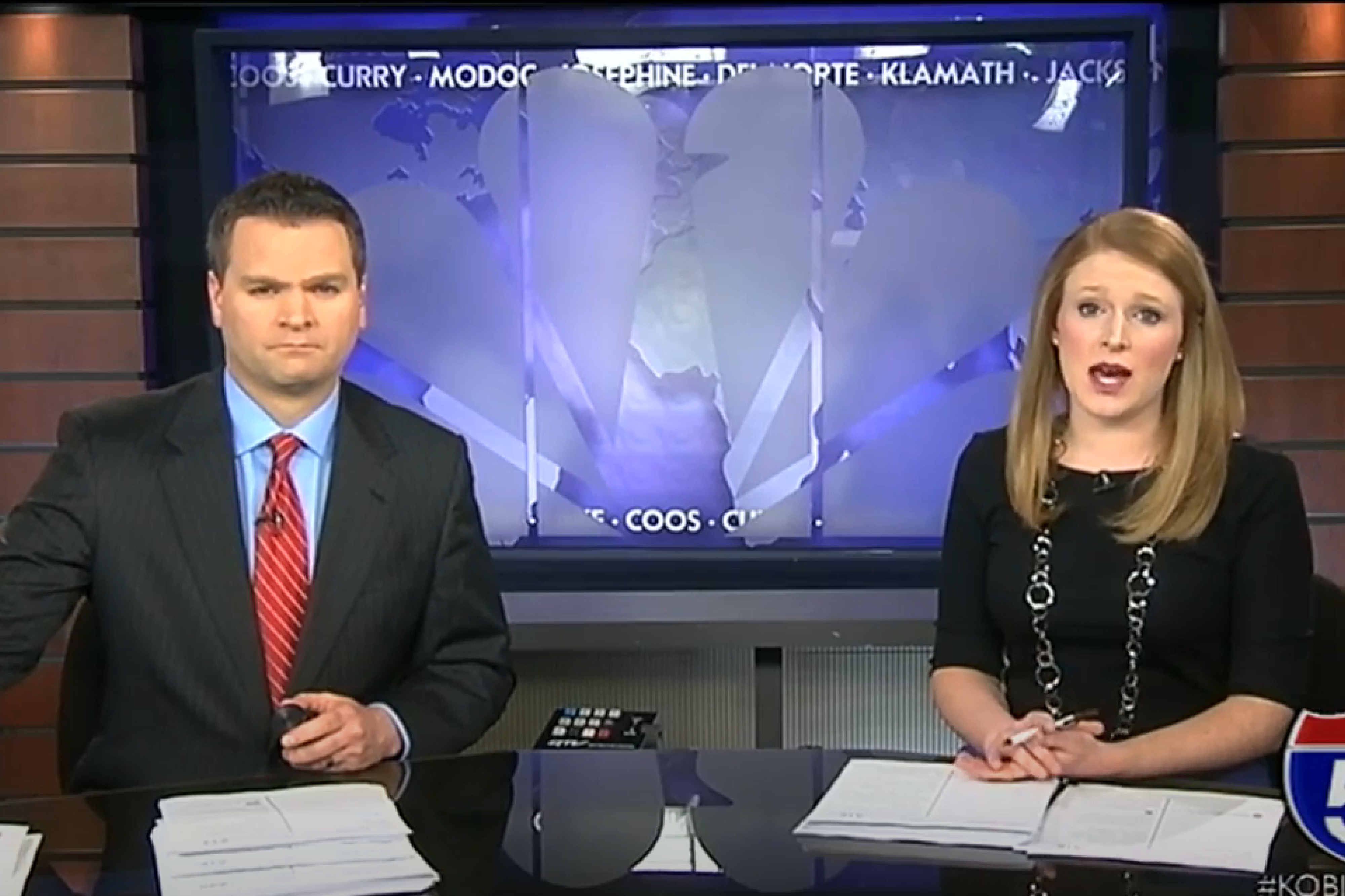 Two TV anchors man and woman on news set