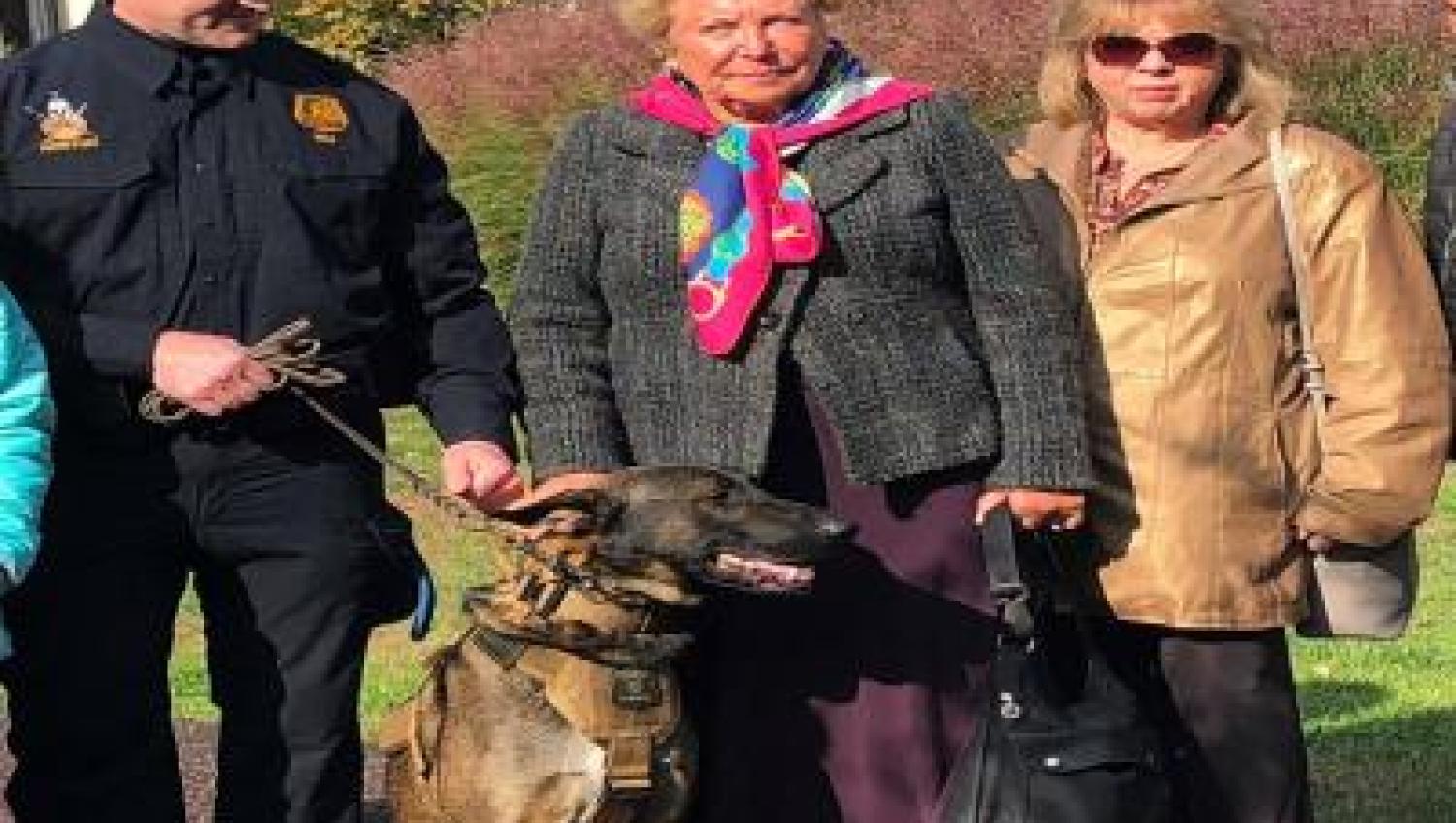 police officer with dog and two adult females