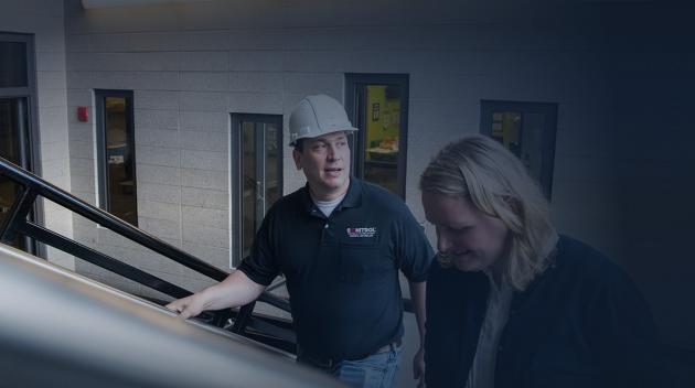 Sonitrol employee conversing with office worker.