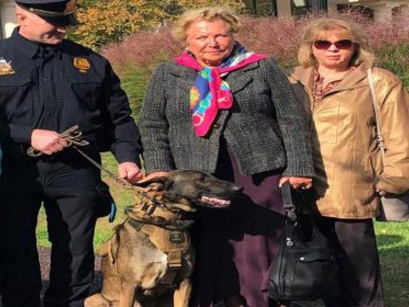 police officer with dog and two adult females