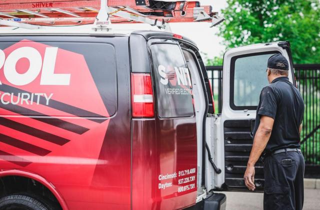 Sonitrol technician loading up a van post install.